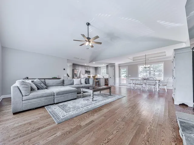 a living room with furniture and wooden floor
