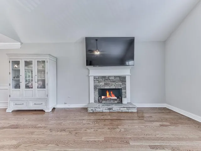a living room with a fireplace and a flat screen tv