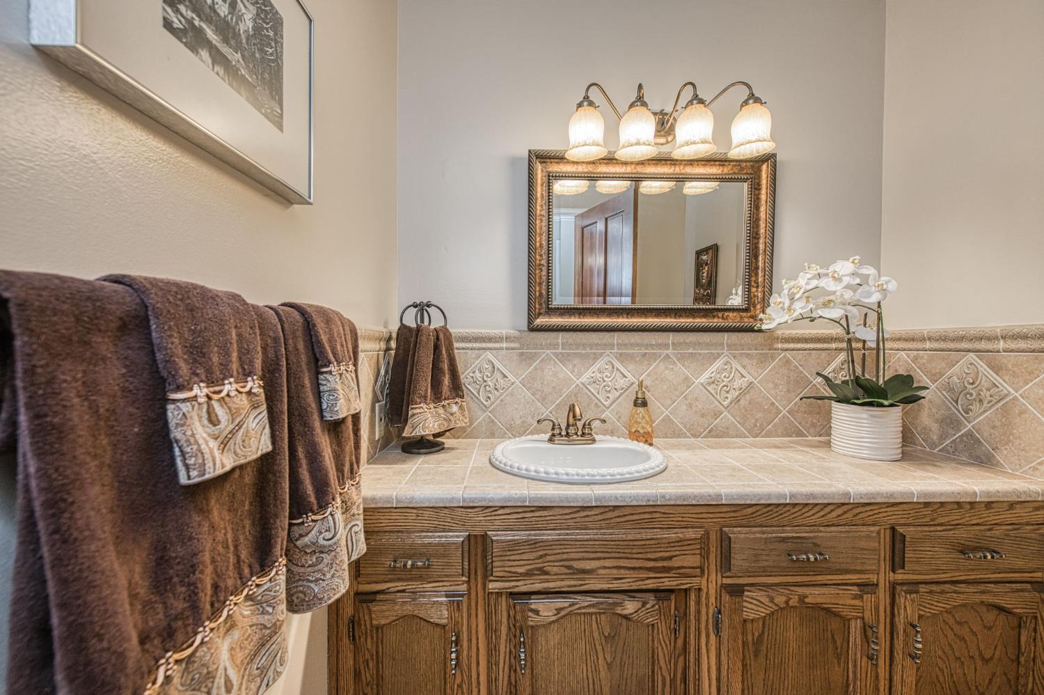 1167 Mill Street Selma, CA 93662 - Photo 18 of 34 a bathroom with a sink and a mirror