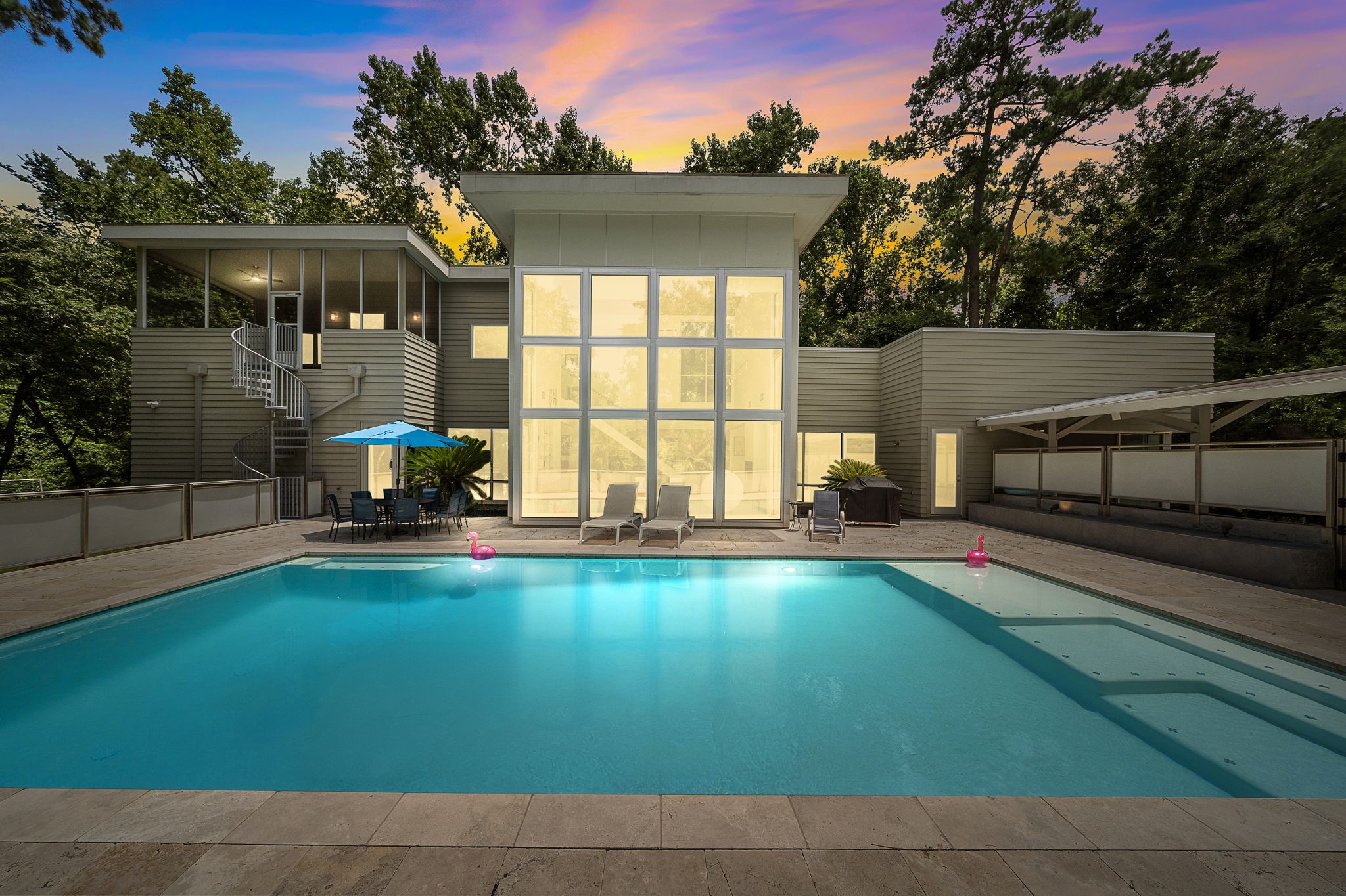 118 Angel Leaf Road The Woodlands, TX 77380 - Photo 49 of 50 Stunning evening pool view with serene lighting and expansive glass façade.