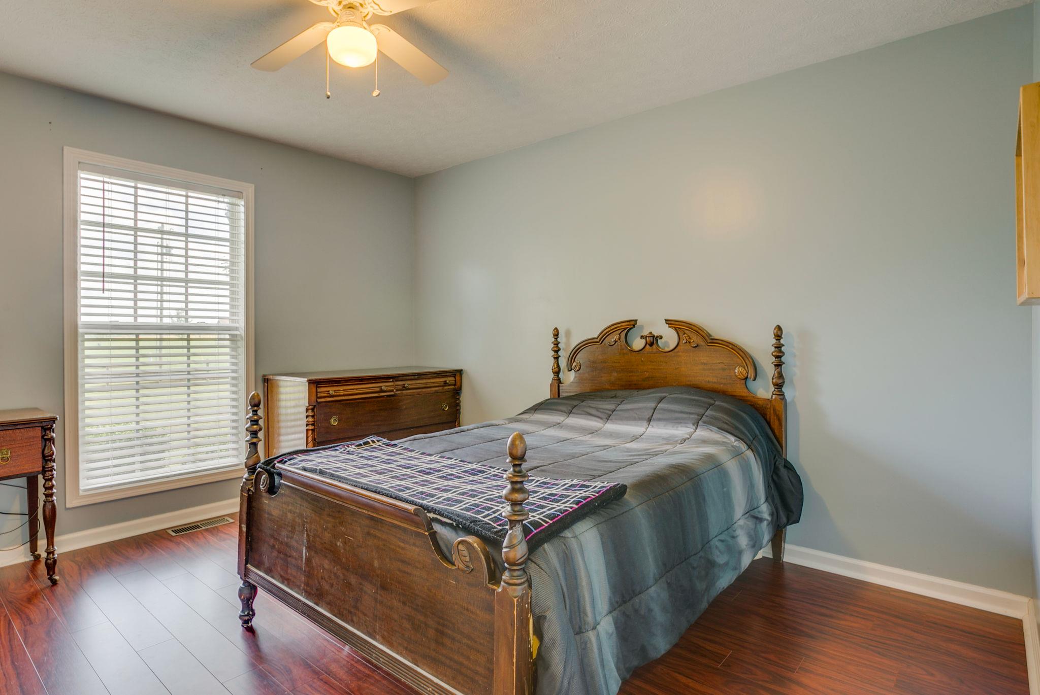 229 Rich Road Unionville, TN 37180 - Photo 28 of 30 a bedroom with a bed and wooden floor