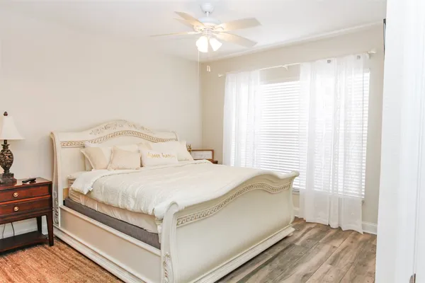 a large bed sitting in a bedroom next to a window
