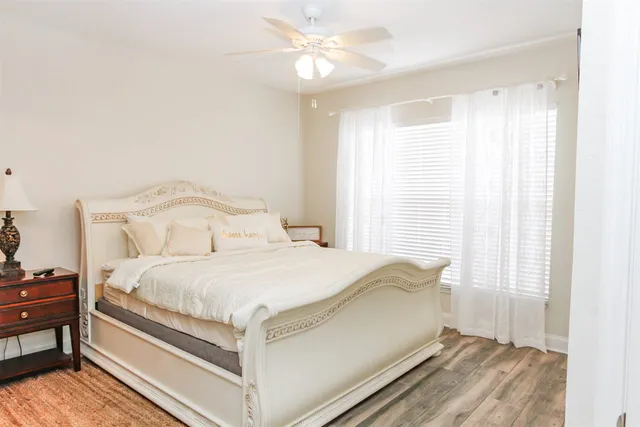 a large bed sitting in a bedroom next to a window