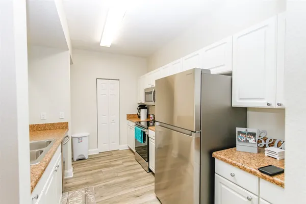 a kitchen with a refrigerator sink and stove