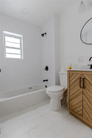 a bathroom with a toilet a sink and a shower