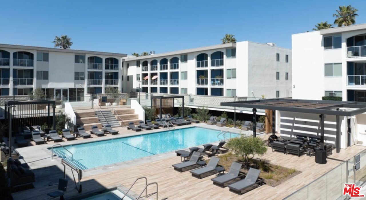 13900 Panay Way, Unit M312 Marina del Rey, CA 90292 - Photo 17 of 21 a view of a swimming pool with a lounge chairs