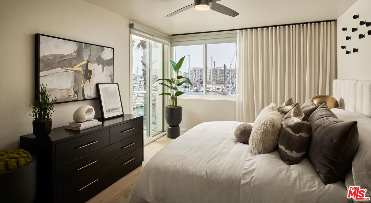 13900 Panay Way, Unit M312 Marina del Rey, CA 90292 - Photo 6 of 21 a bedroom with a bed dresser and window