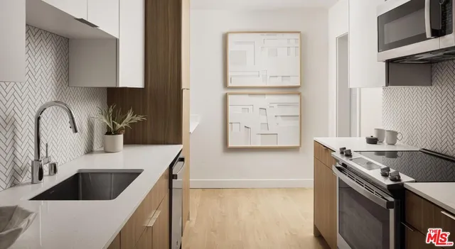 a kitchen with a sink cabinets and a stove