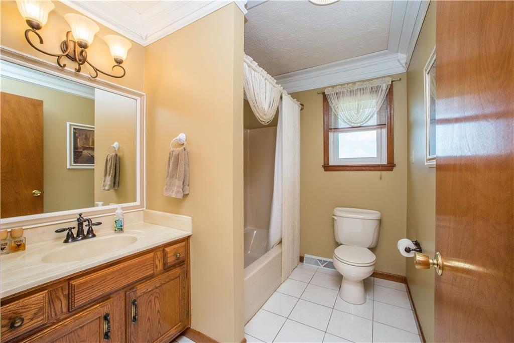 662 Bocktown Cork Road Clinton, PA 15026 - Photo 14 of 25 The master bath has a wide vanity, tiled floor, and combination tub/shower.