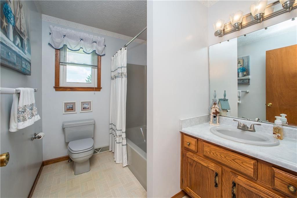 662 Bocktown Cork Road Clinton, PA 15026 - Photo 17 of 25 The home's main bath is located on the upper level and has a wide vanity and tub with shower.