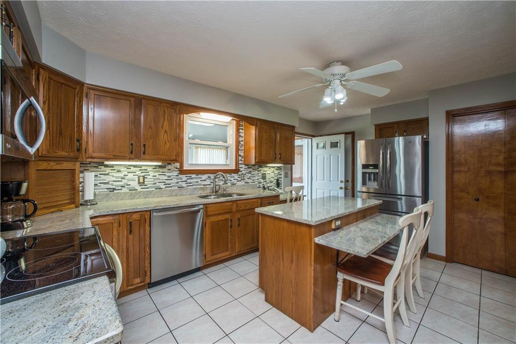 662 Bocktown Cork Road Clinton, PA 15026 - Photo 6 of 25 The kitchen has been updated with granite counters and stainless steel appliances. The open door right center of the photo leads to the sunroom. The pantry is seen on the right edge of the photo.