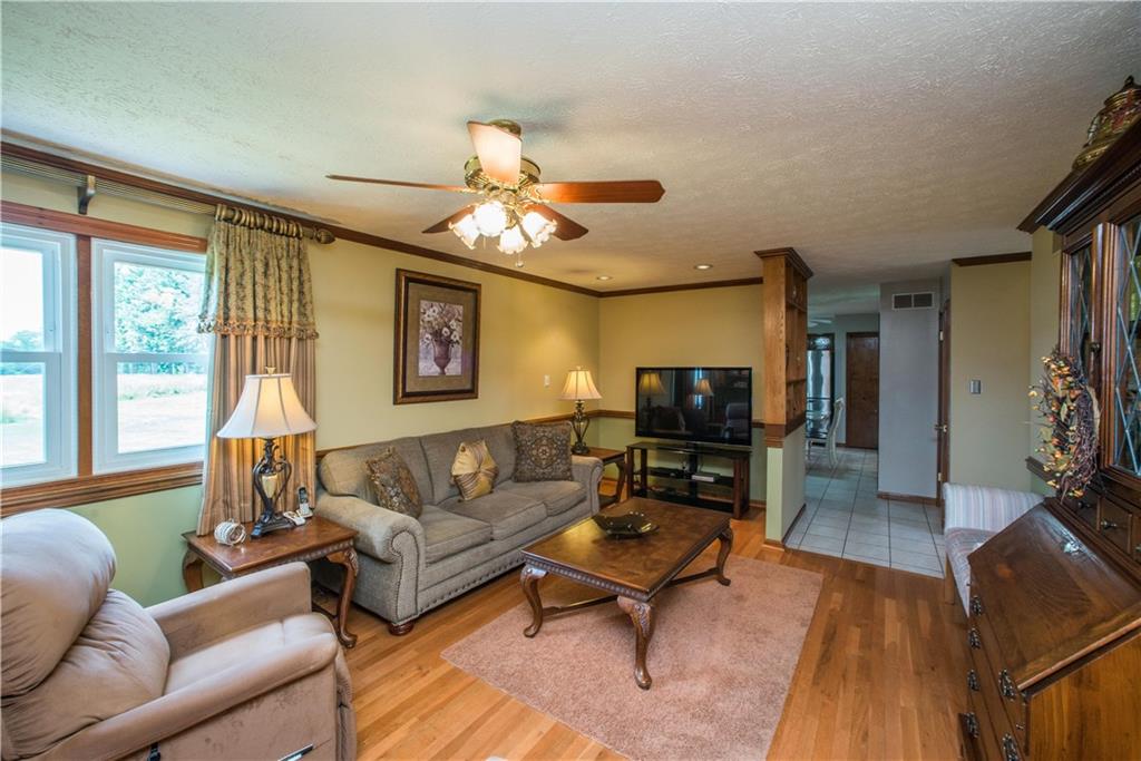 662 Bocktown Cork Road Clinton, PA 15026 - Photo 8 of 25 Steps from the kitchen is the main level family room. The room overlooks the rear of the property and has ceiling fan to stir the air on a warm afternoon when air conditioning is not needed.