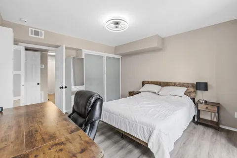 a bedroom with a bed and a chair