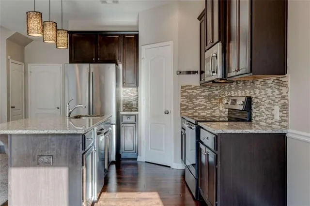 a bathroom with a granite countertop sink a washer and dryer