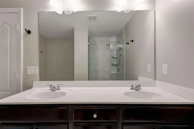 a bathroom with a sink double vanity and a mirror