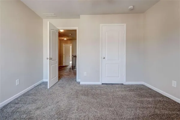 a view of an empty room and closet