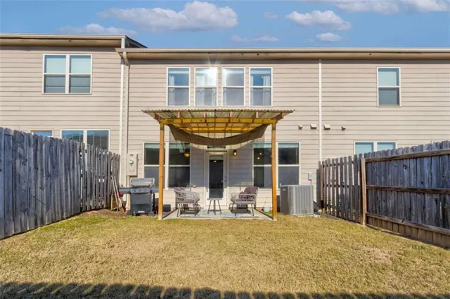 a view of a house with wooden fence