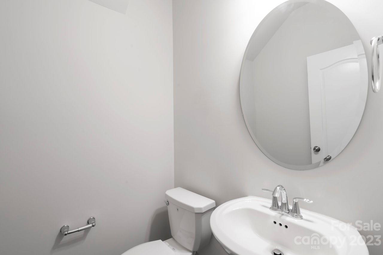 18209 Kalabash Road Charlotte, NC 28278 - Photo 12 of 48 a bathroom with a sink mirror and toilet