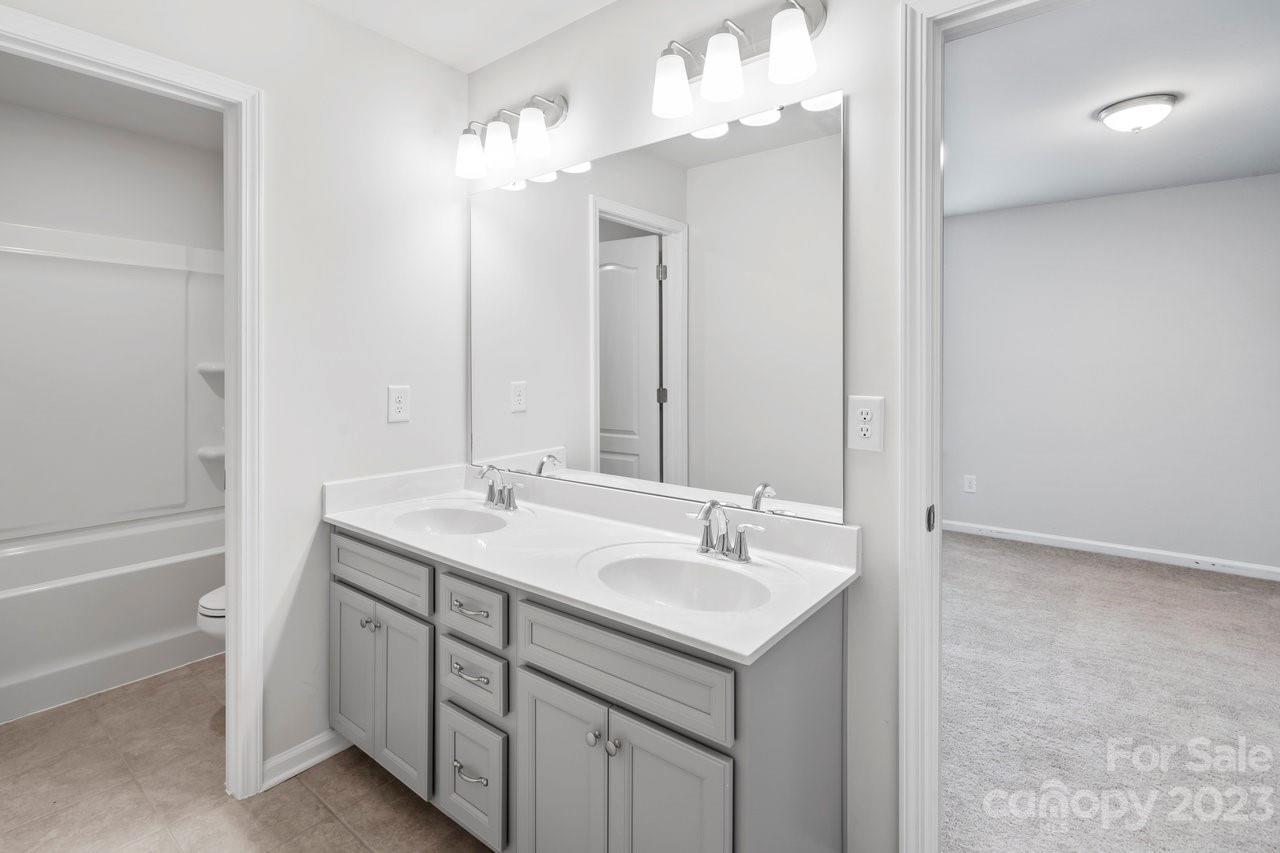 18209 Kalabash Road Charlotte, NC 28278 - Photo 18 of 48 a bathroom with a sink double vanity and a mirror