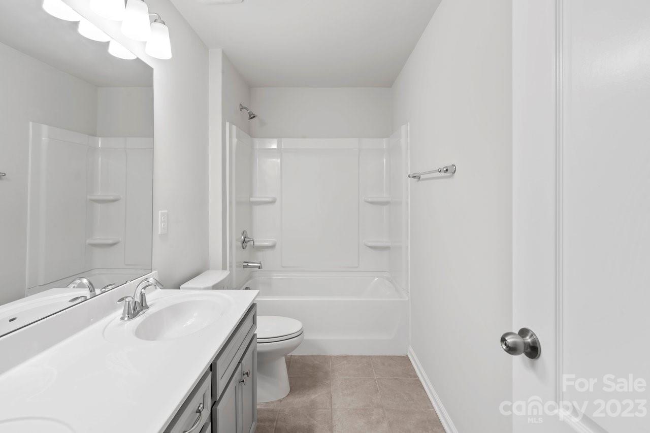 18209 Kalabash Road Charlotte, NC 28278 - Photo 19 of 48 a bathroom with a sink a toilet and shower