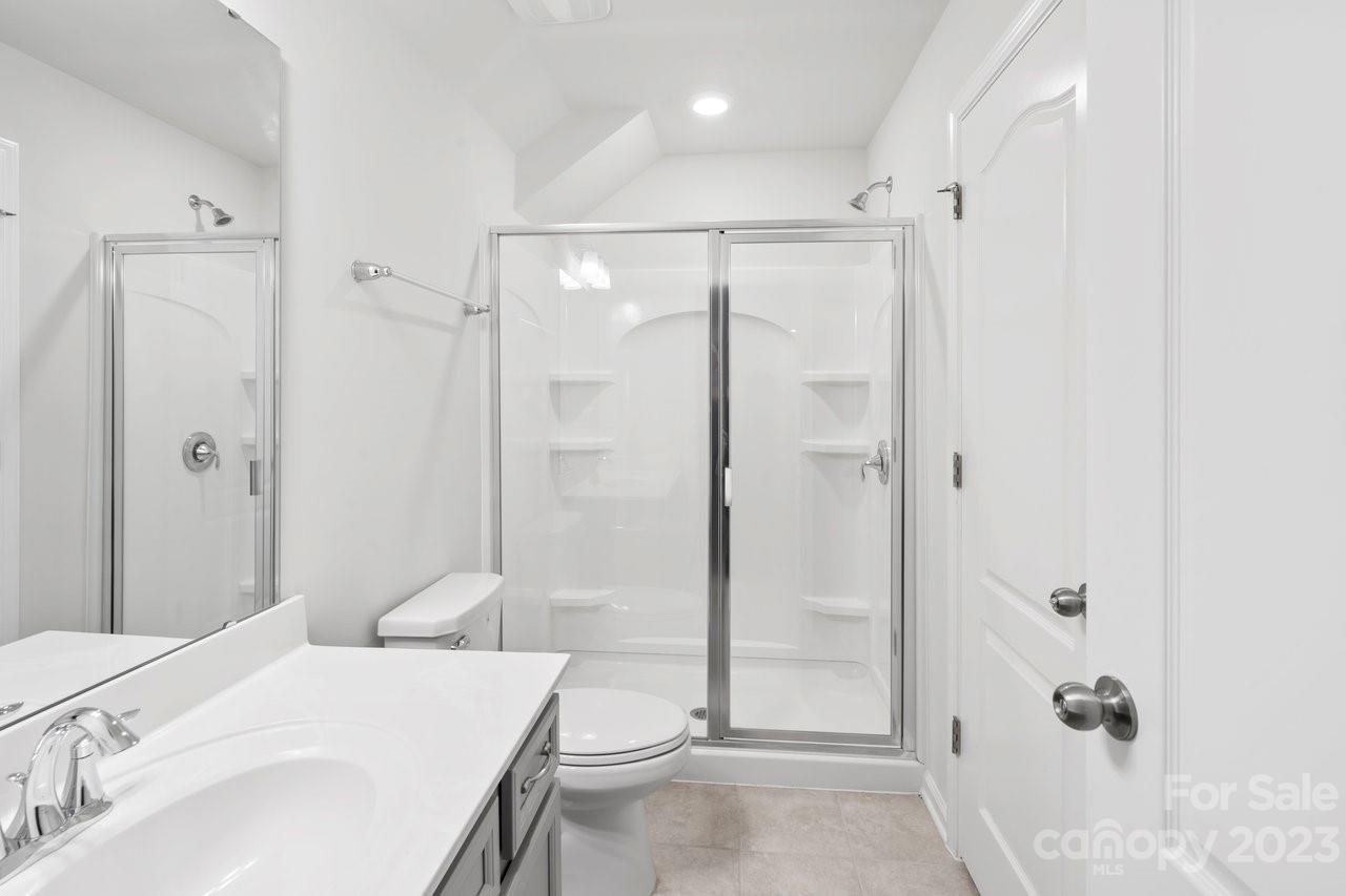 18209 Kalabash Road Charlotte, NC 28278 - Photo 31 of 48 a bathroom with a tub shower sink and mirror