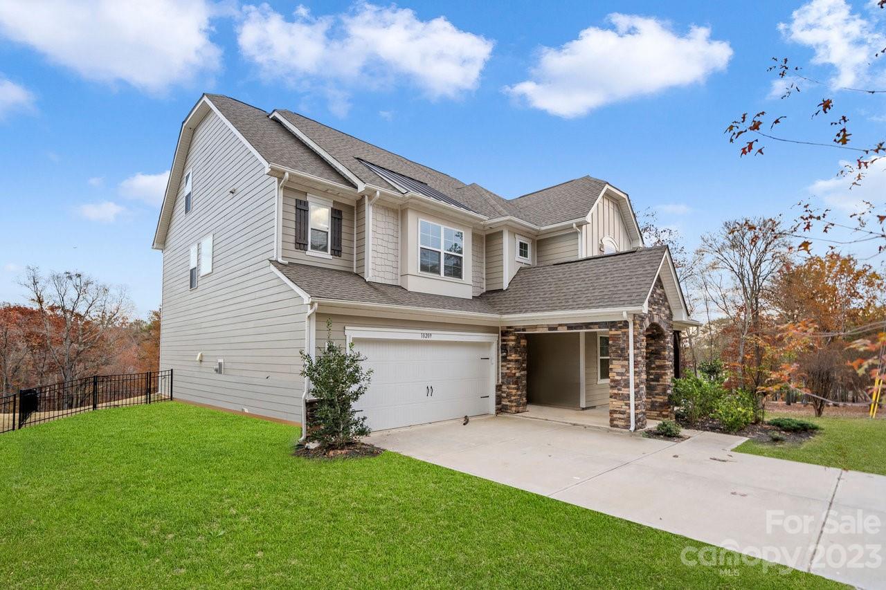 18209 Kalabash Road Charlotte, NC 28278 - Photo 33 of 48 a front view of a house with a garden and yard