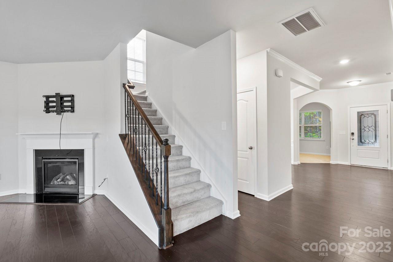18209 Kalabash Road Charlotte, NC 28278 - Photo 5 of 48 a view of a hallway with wooden floor and staircase