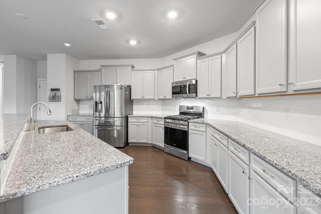 18209 Kalabash Road Charlotte, NC 28278 - Photo 7 of 48 a kitchen with stainless steel appliances granite countertop a sink stove and refrigerator