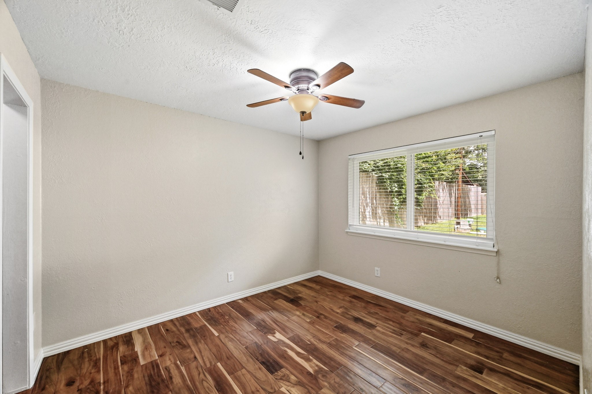 3602 Sweet Gum Spring, TX 77388 - Photo 22 of 30 a view of an empty room with window and a ceiling fan