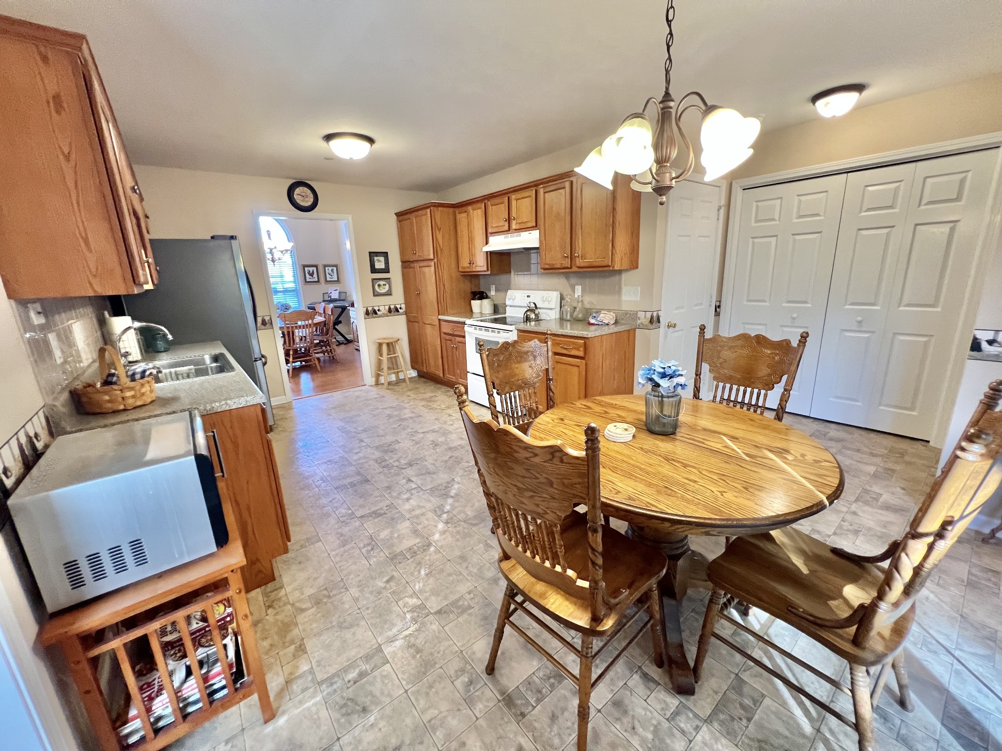 291 Bailey Lane Pleasant View, TN 37146 - Photo 15 of 37 a dining room with furniture a rug a potted plant and a chandelier