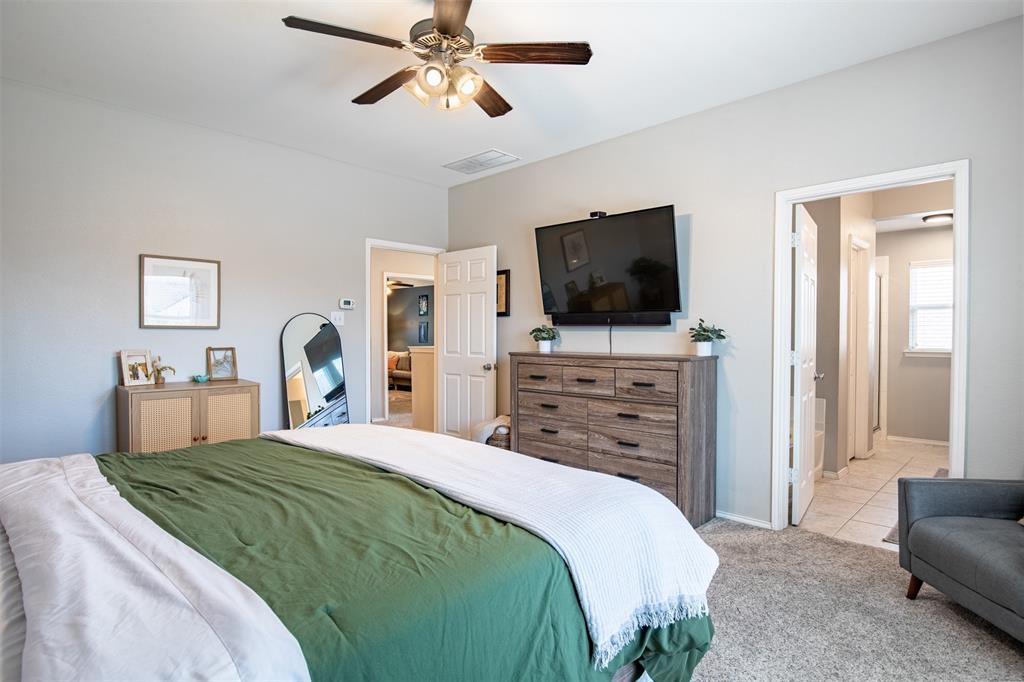 416 Allbright Road Celina, TX 75009 - Photo 20 of 40 a bedroom with a bed and a flat screen tv