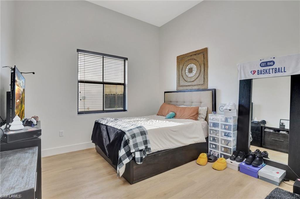 5123 Genoa Street Ave Maria, FL 34142 - Photo 11 of 34 a bedroom with a bed and a tv on the dresser