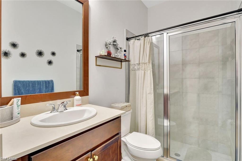 5123 Genoa Street Ave Maria, FL 34142 - Photo 12 of 34 a bathroom with a sink toilet and shower
