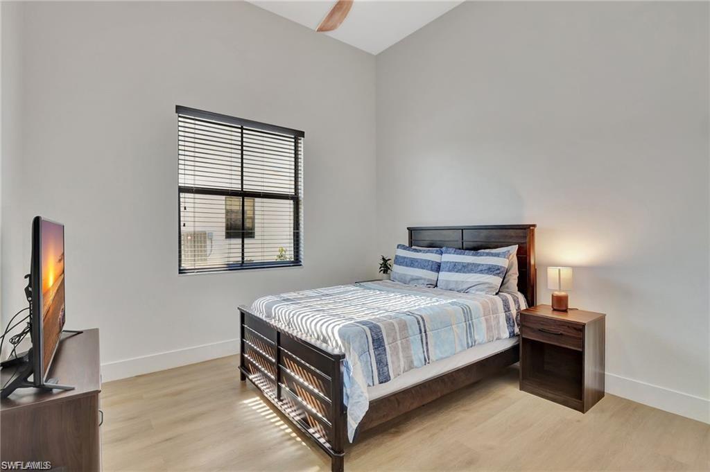 5123 Genoa Street Ave Maria, FL 34142 - Photo 13 of 34 a bed sitting in a bedroom next to a window