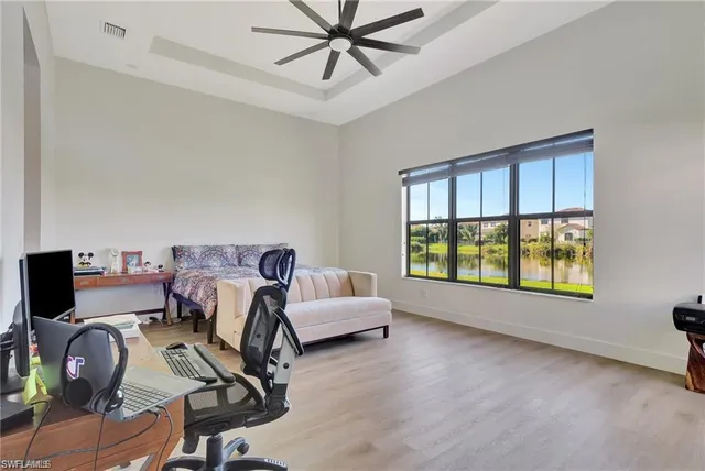 a view of a workspace with furniture and a window