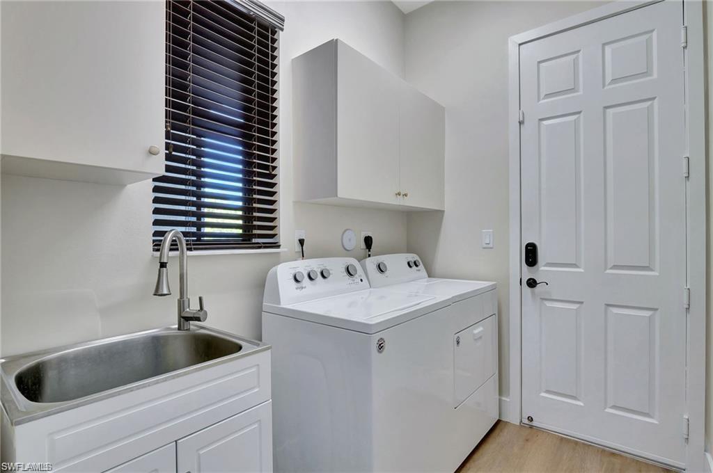 5123 Genoa Street Ave Maria, FL 34142 - Photo 17 of 34 a utility room with dryer and washer