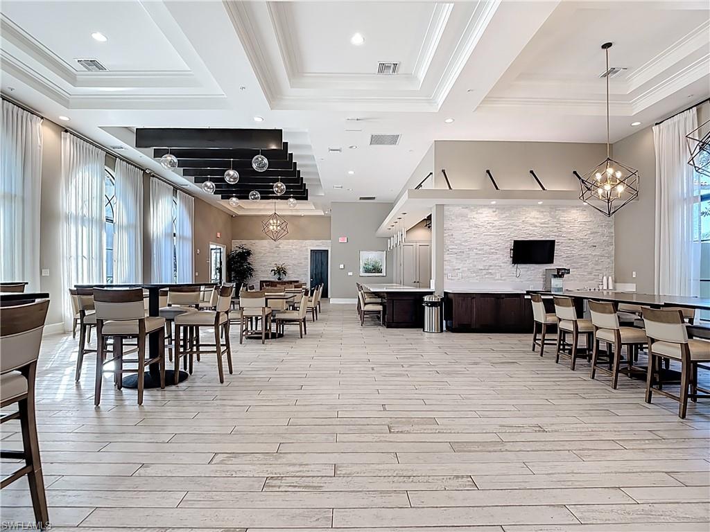 5123 Genoa Street Ave Maria, FL 34142 - Photo 22 of 34 a view of a dining room with furniture window and wooden floor