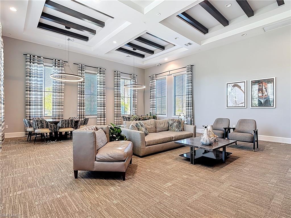 5123 Genoa Street Ave Maria, FL 34142 - Photo 25 of 34 a living room with furniture floor to ceiling window and a flat screen tv
