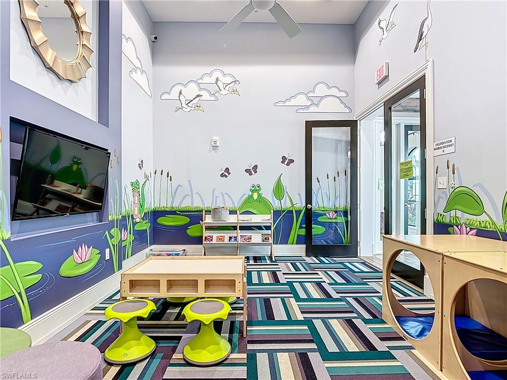 5123 Genoa Street Ave Maria, FL 34142 - Photo 28 of 34 a living room filled with furniture and a flat screen tv