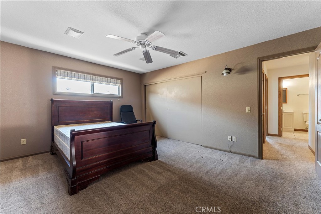 32451 Valyermo Road Pearblossom, CA 93553 - Photo 18 of 38 a room with window and ceiling fan