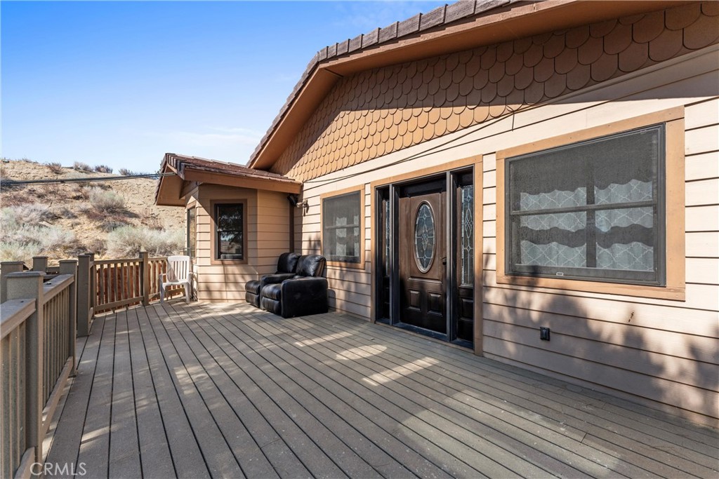 32451 Valyermo Road Pearblossom, CA 93553 - Photo 3 of 38 a view of a balcony with wooden floor