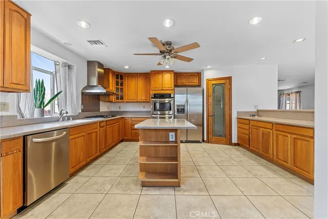 a kitchen with stainless steel appliances a sink counter space and a window