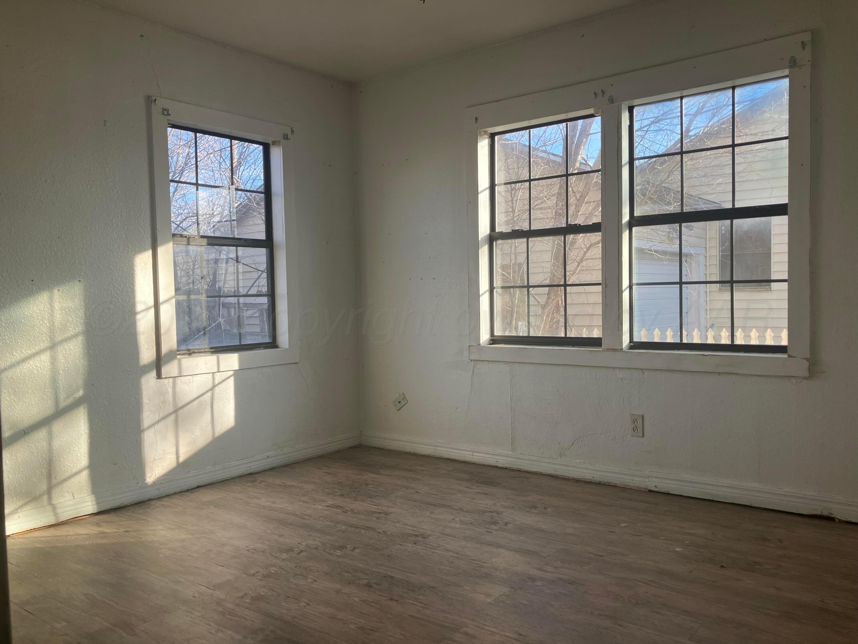 3619 South Travis Street Amarillo, TX 79110 - Photo 6 of 9 an empty room with a window