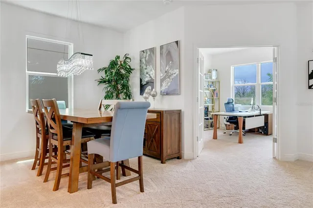 a view of a dining room with furniture and a potted plant
