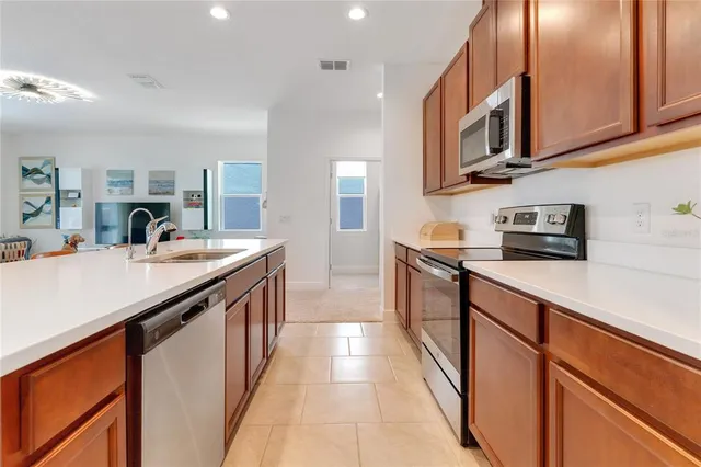 a kitchen with stainless steel appliances granite countertop a sink and cabinets