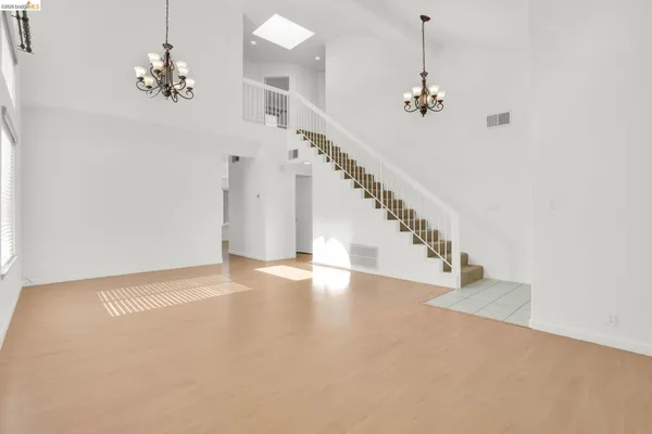a view of an empty room with glass door and balcony
