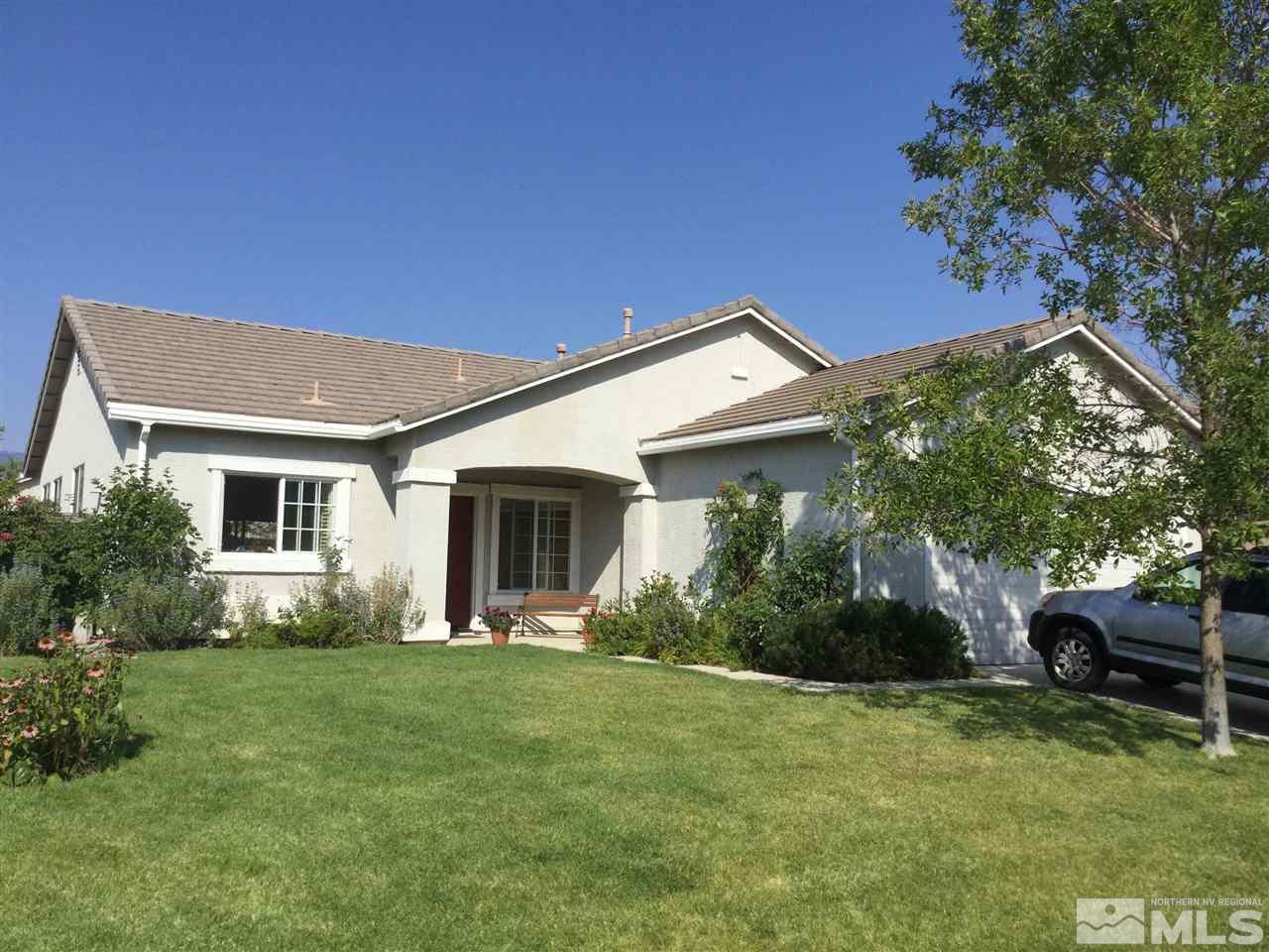 10235 Lucente Way Reno, NV 89521 - Photo 1 of 1 a front view of house with yard and green space