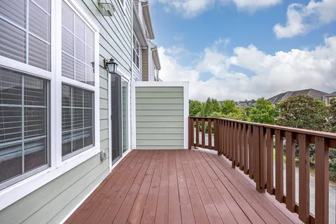 a balcony with wooden floor and fence