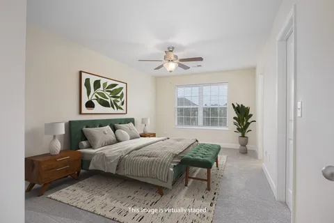 a bedroom with a bed furniture and a window