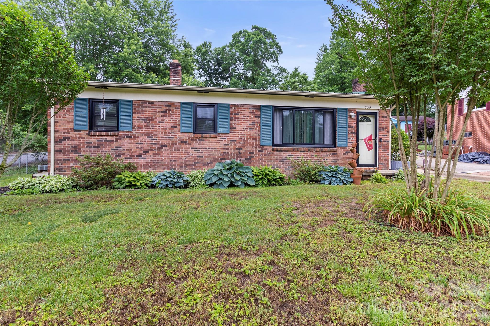 325 Swanson Road Lenoir, NC 28645 - Photo 1 of 35 a front view of a house with a garden